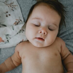 a baby lying on a bed